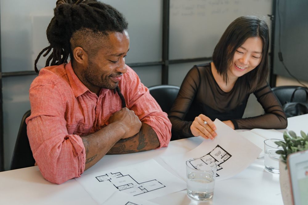 The DICTAC design team reviewing furniture plans